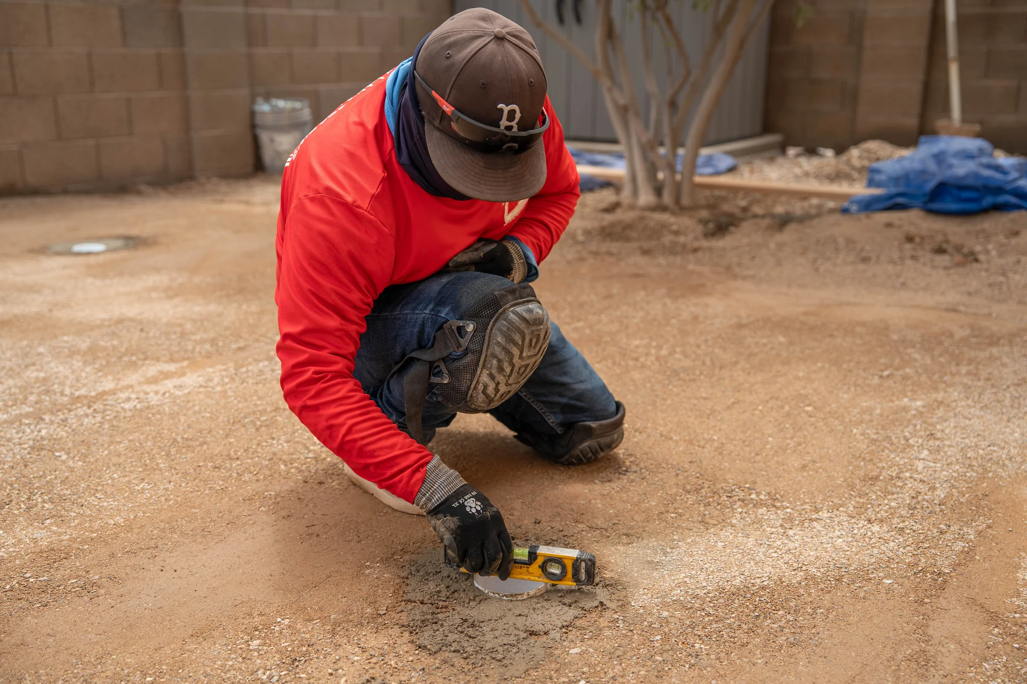 Worker checks ground level with a spirit level