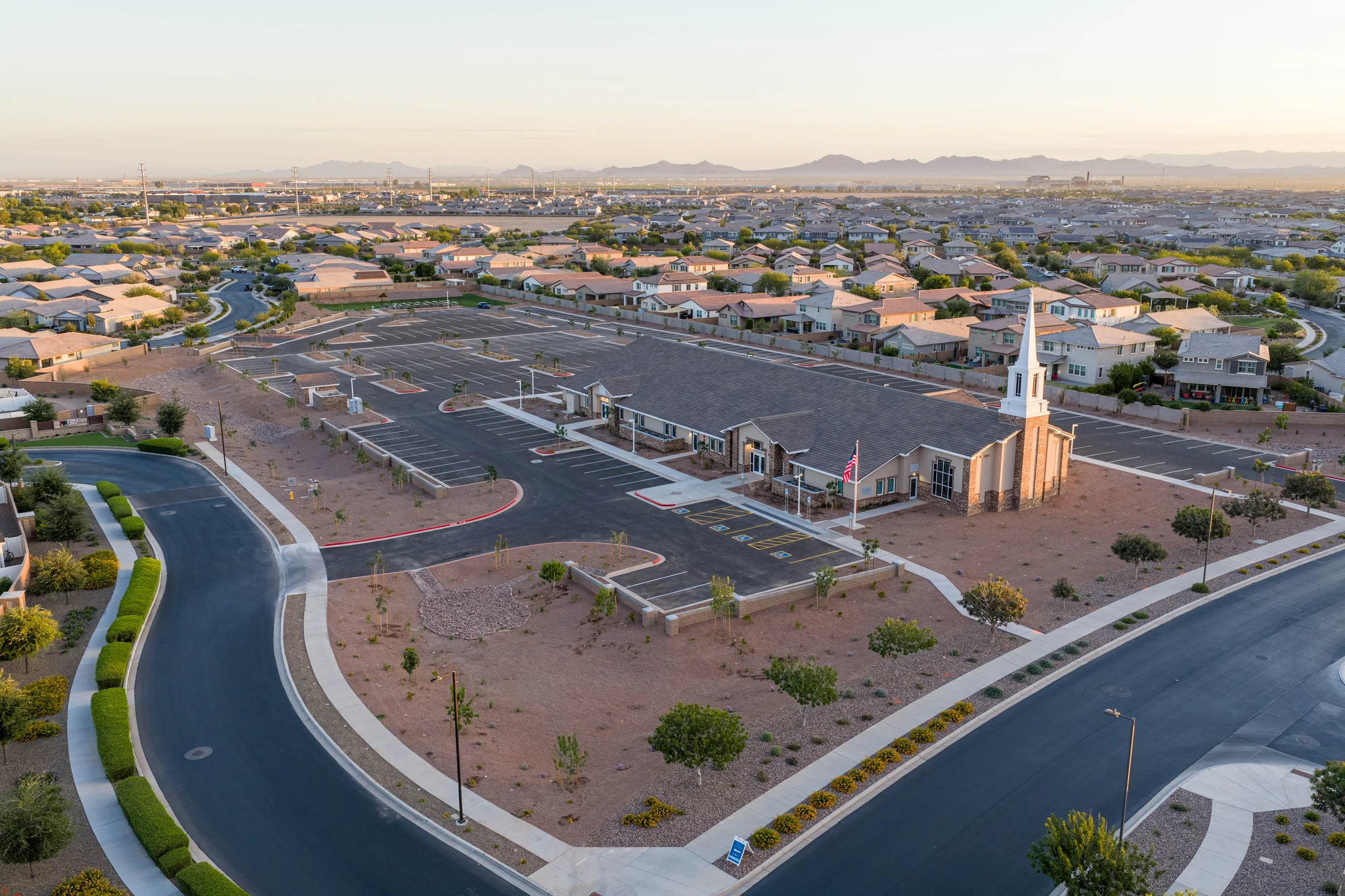 Aerial view of suburban church with steeple and parking lot