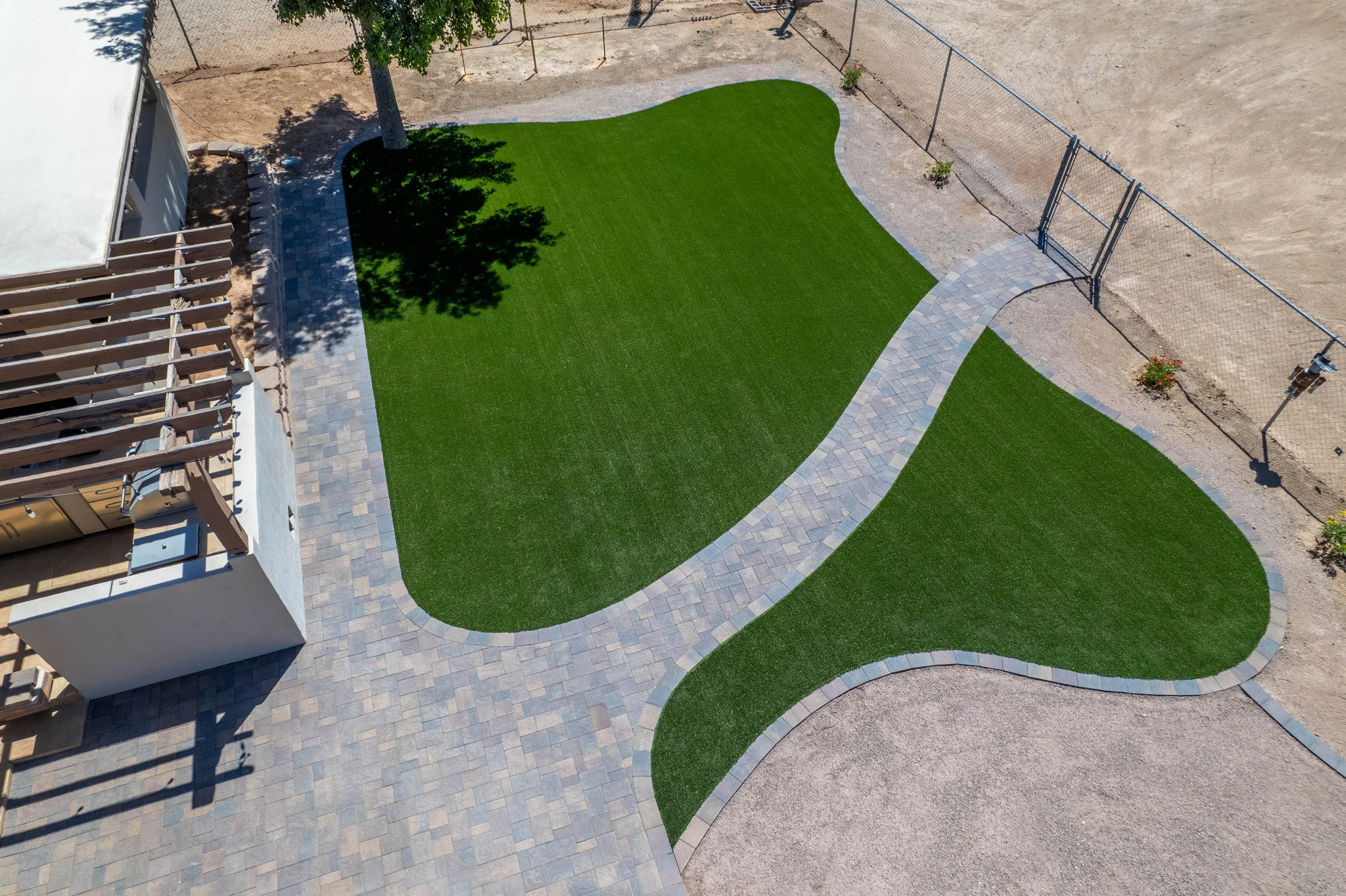 Aerial view of artificial turf yard and paver walkway