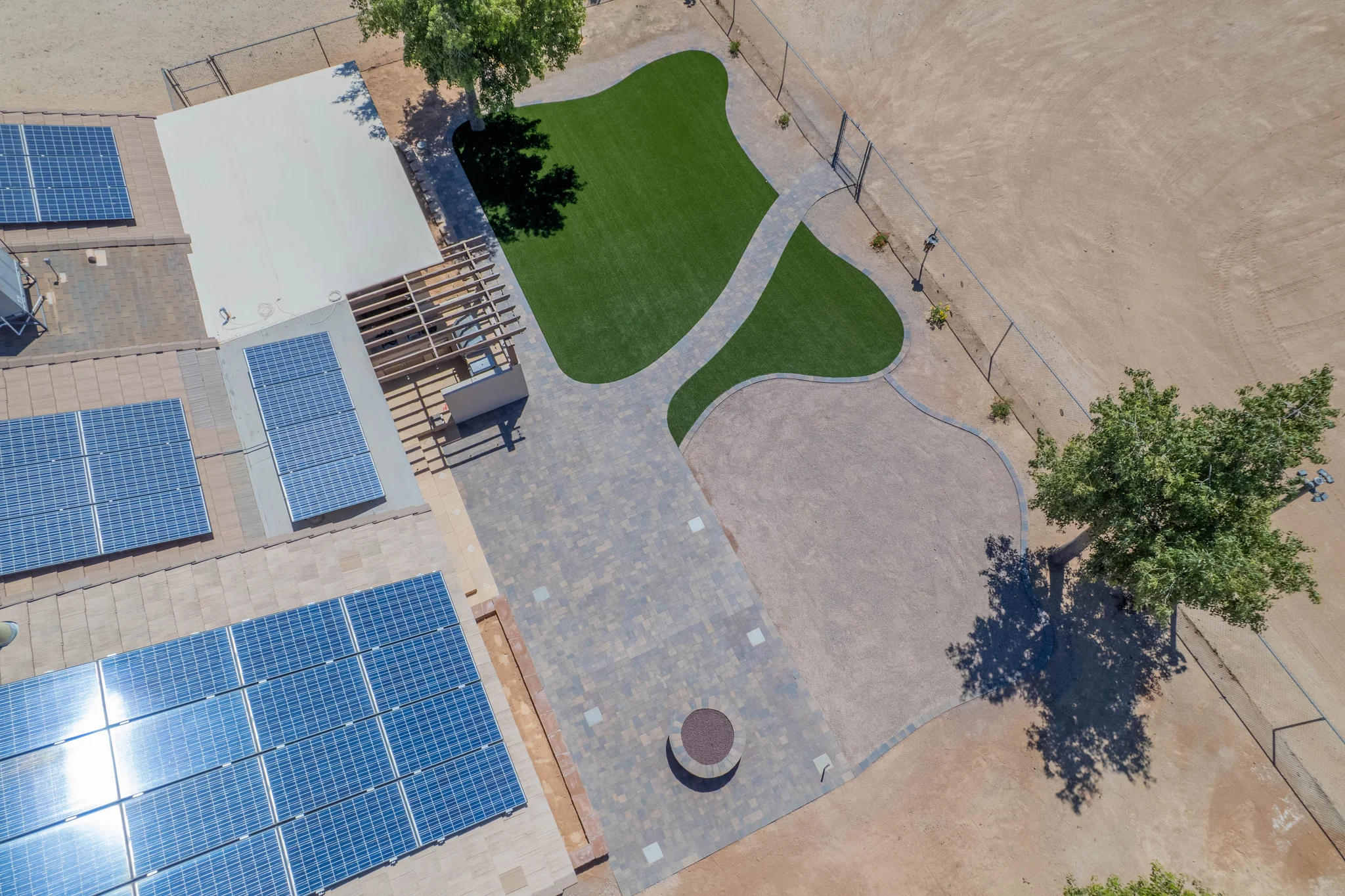 Aerial view of solar-roofed building and landscaped courtyard