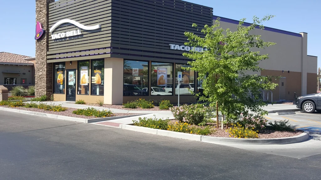 Modern Taco Bell restaurant exterior with landscaped parking lot