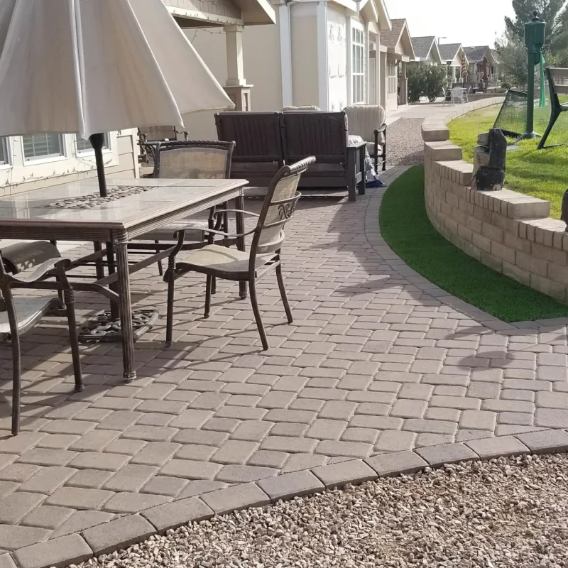 Paver patio with outdoor furniture beside suburban homes