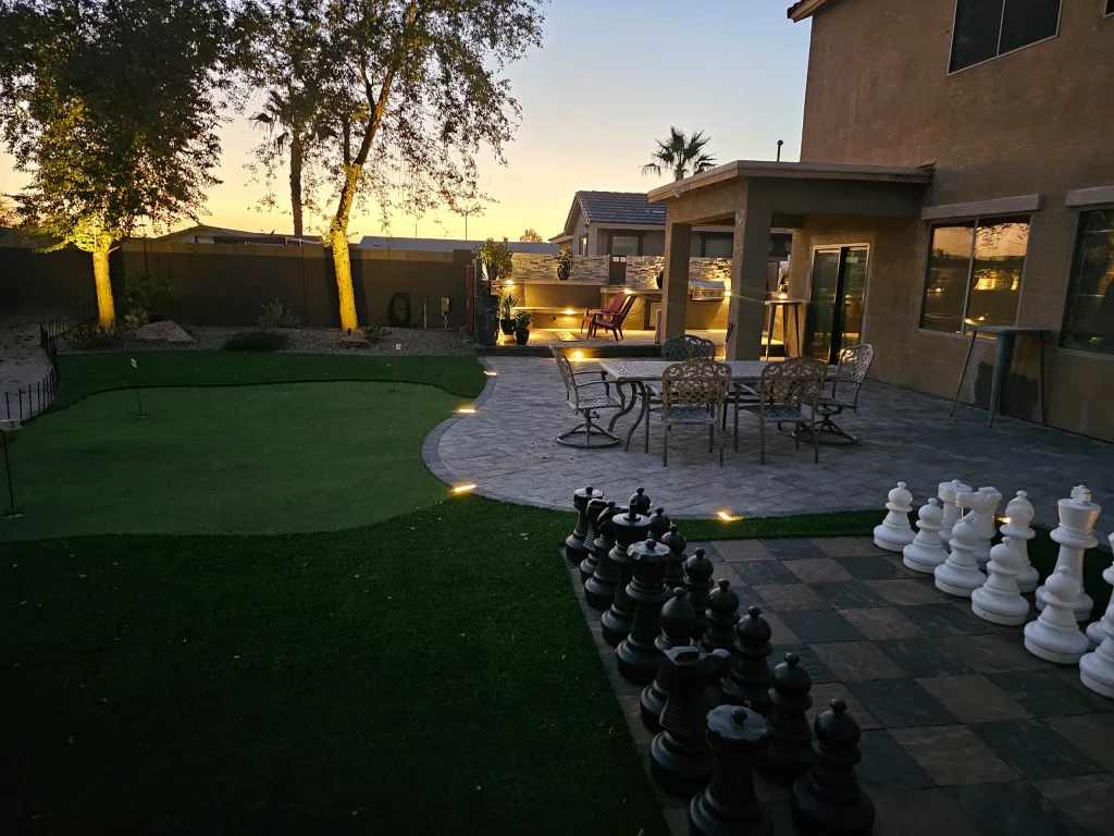 Backyard patio with giant chess set at sunset