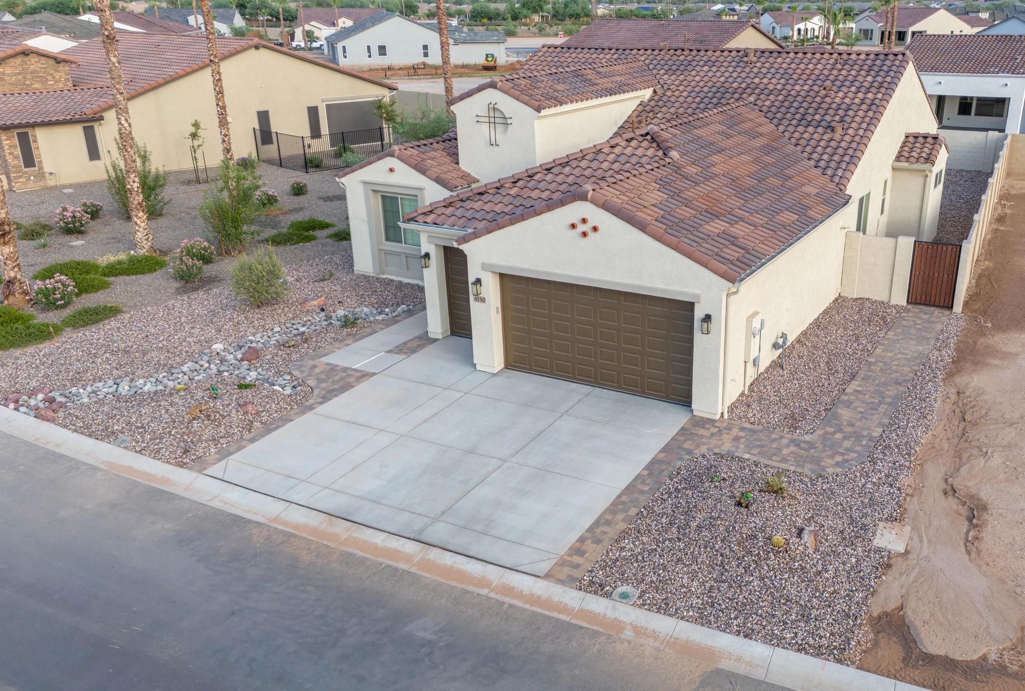 Aerial view of stucco home with tile roof