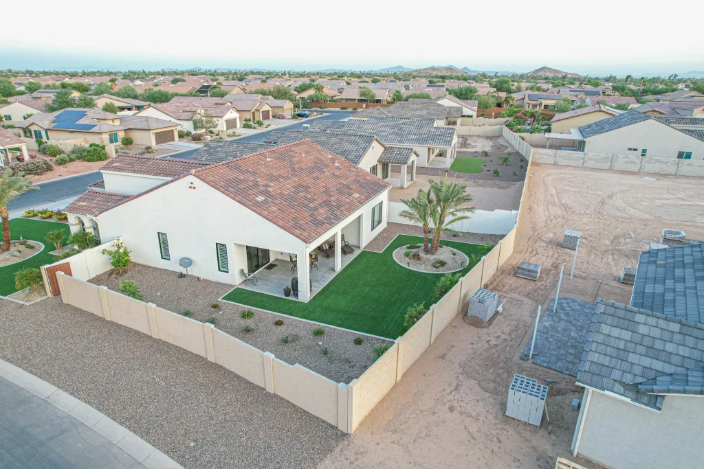 Aerial view of suburban home with landscaped backyard