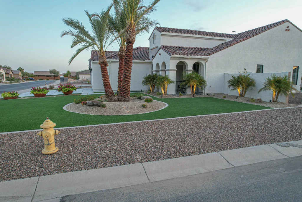 Palm-lined desert landscaping outside a white stucco home