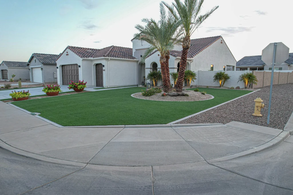 Desert home with palm trees and manicured artificial lawn