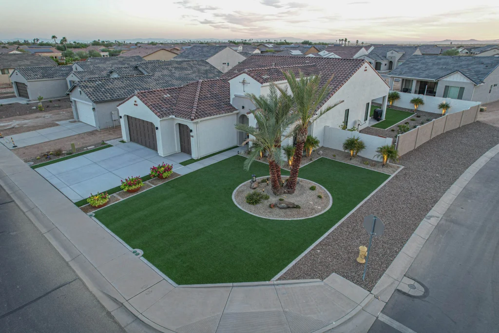 Aerial view of suburban corner home with palm trees
