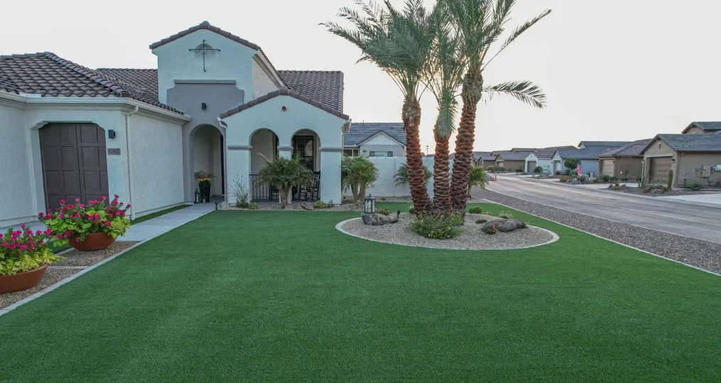 Desert home with artificial lawn and palm trees