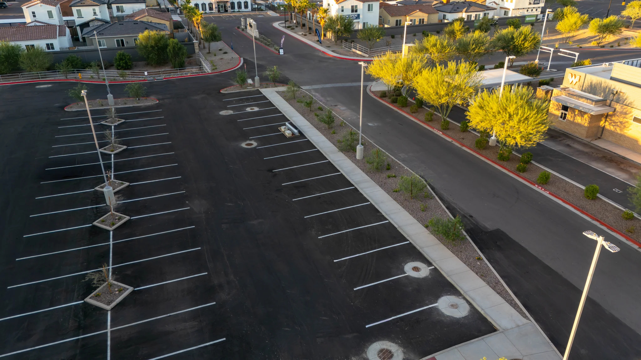 Aerial view of empty commercial parking lot at sunset