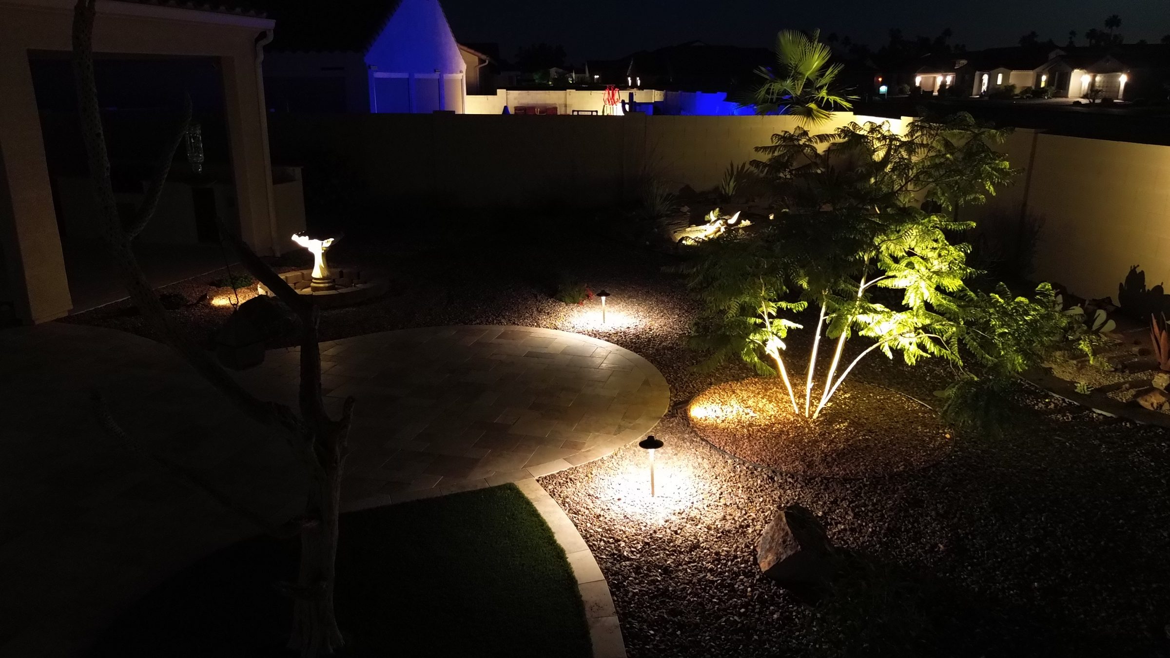 Illuminated backyard garden path at night