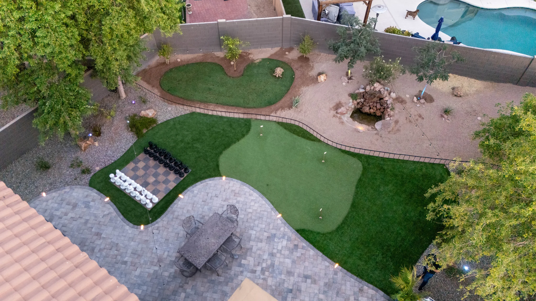 Aerial view of backyard putting green and giant chessboard