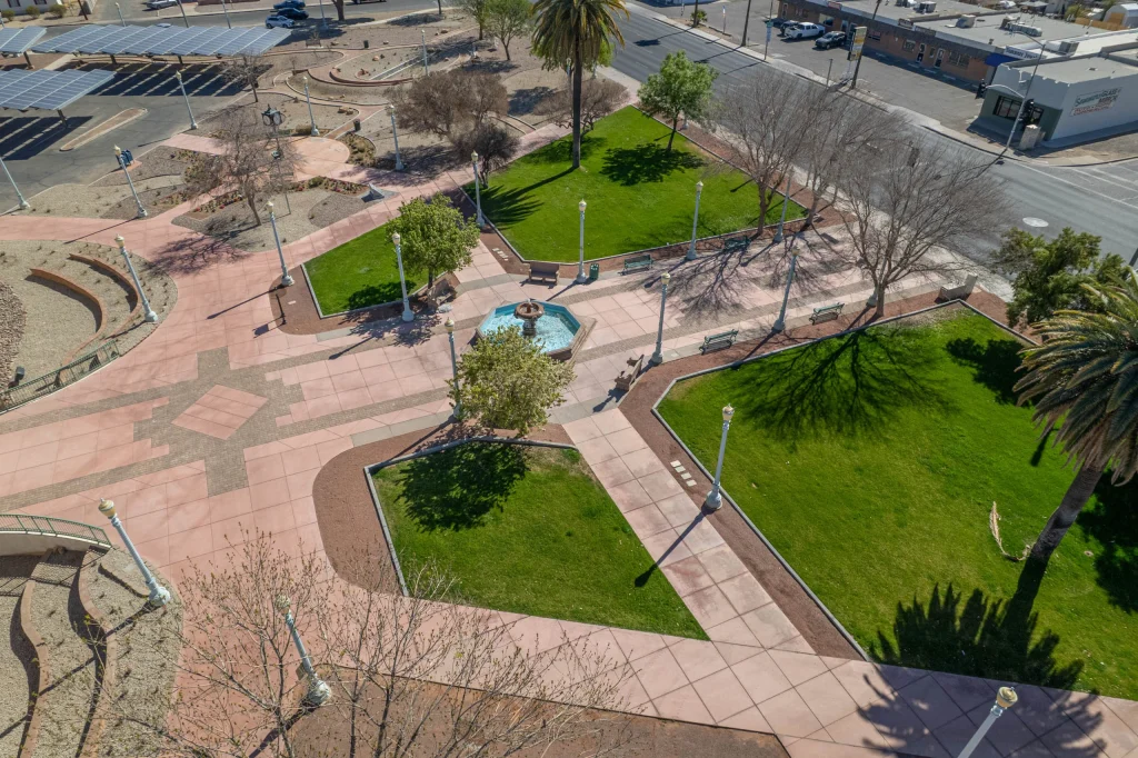 Aerial view of landscaped plaza with fountain and lawns