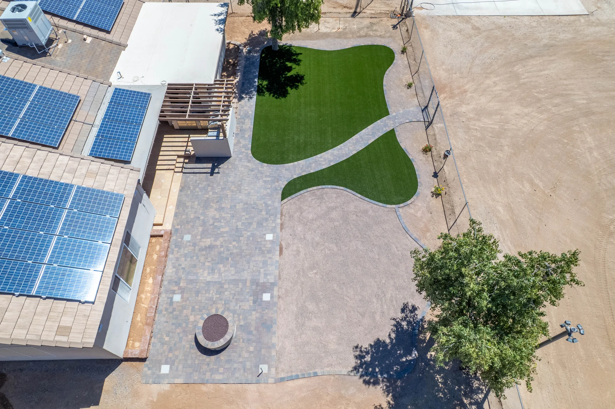 Aerial view of solar-roofed home and landscaped yard