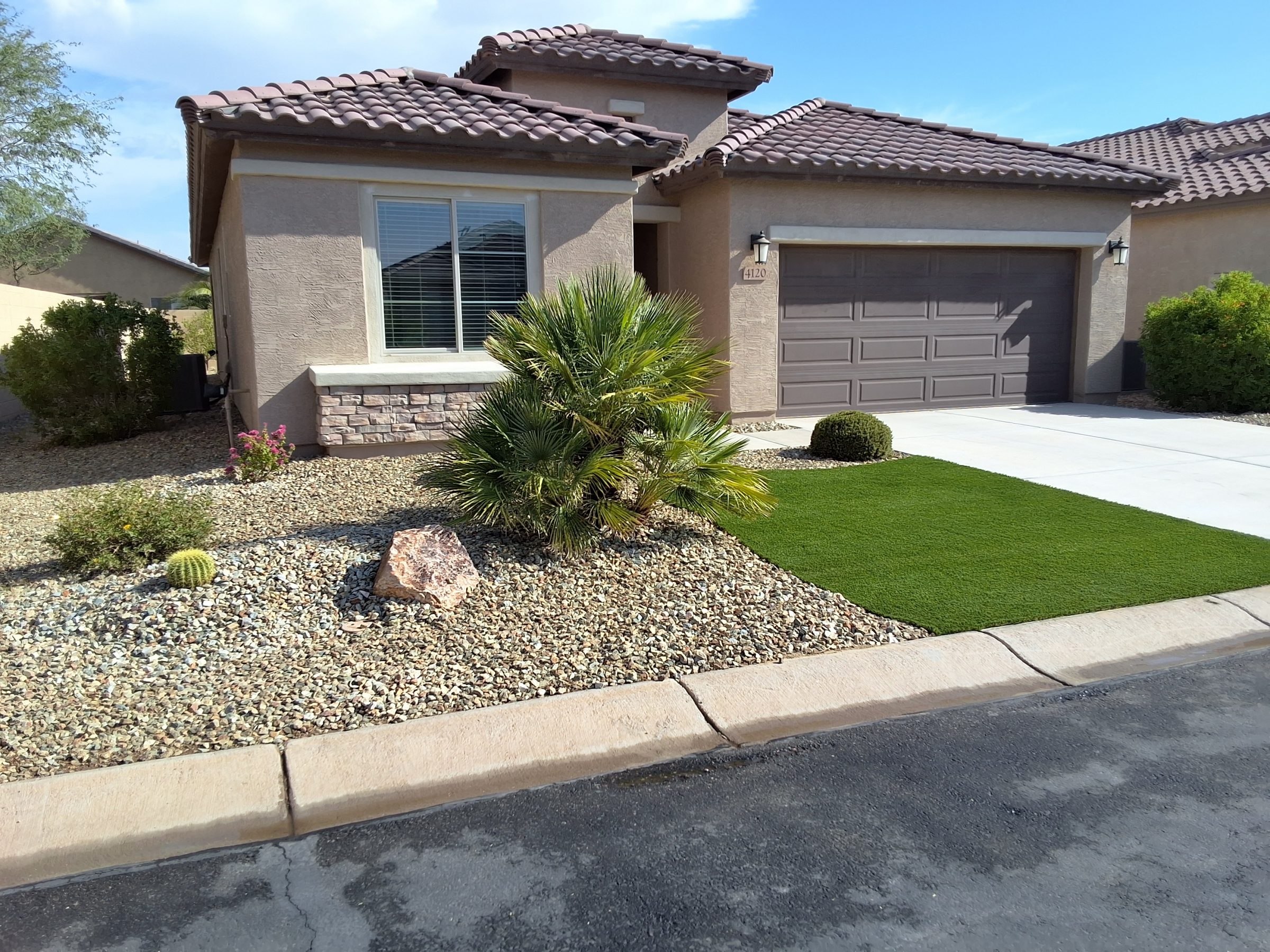 Stucco home with tile roof and desert landscaping