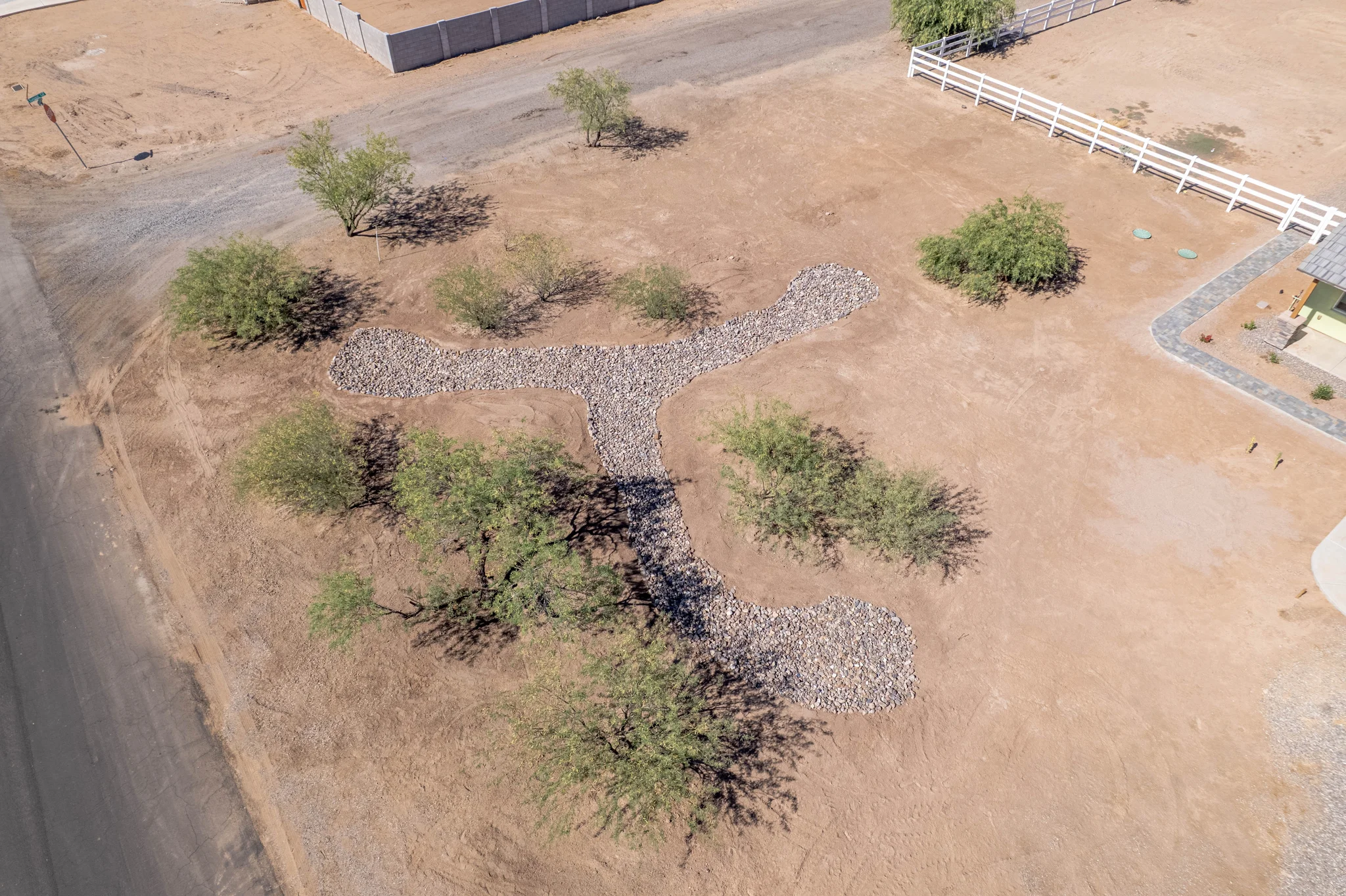 Aerial view of rock-lined desert drainage channel